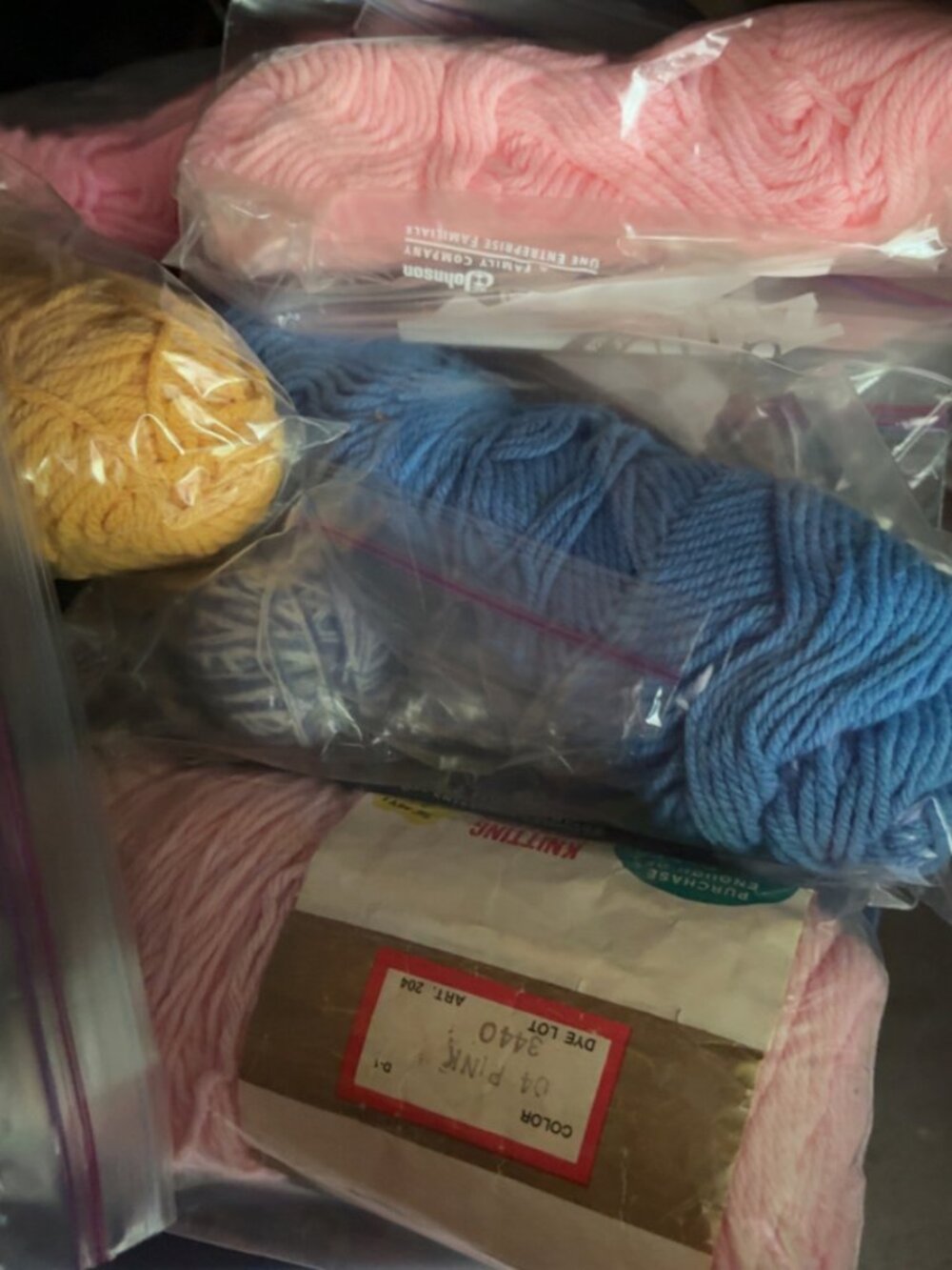 Lot of yarn in pink, blue, orange, and cream colors